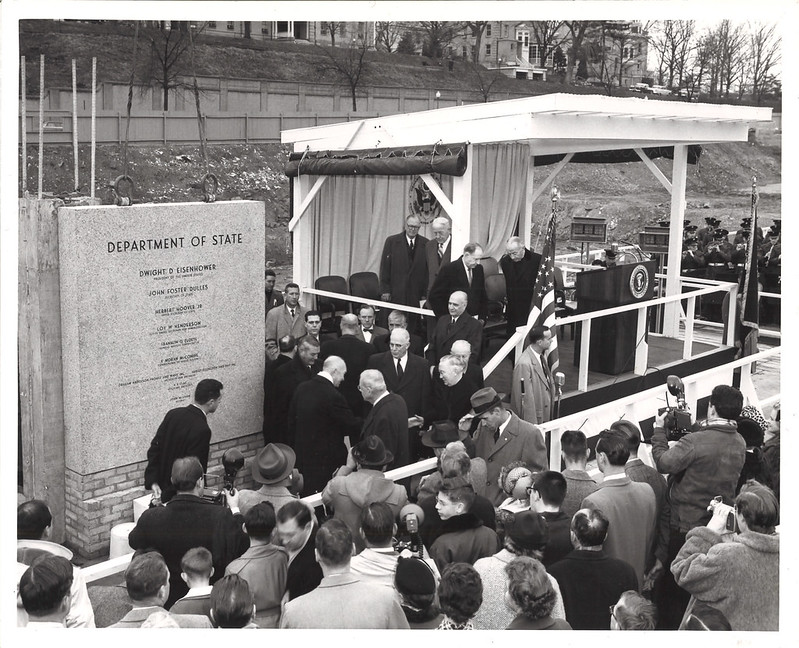 President Eisenhower and Secretary of State John Foster Dulles at the laying of the cornerstone for the New State Building. Pictured near President Eisenhower are Chief Justice Earl Warren (center) and Ambassador Loy Henderson (far right), January 5, 1957. Photo credit: State Dept.
