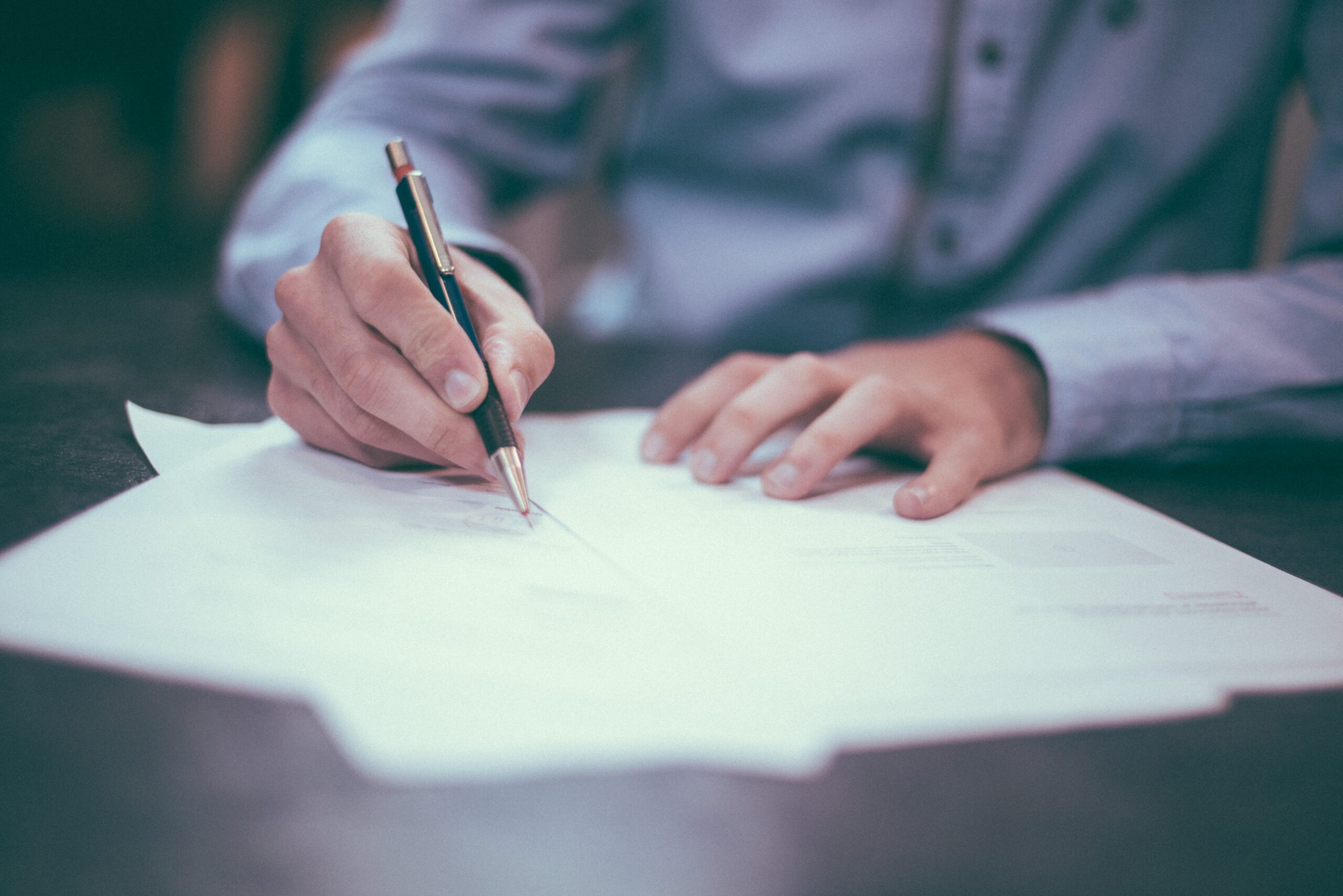 person writing on papers