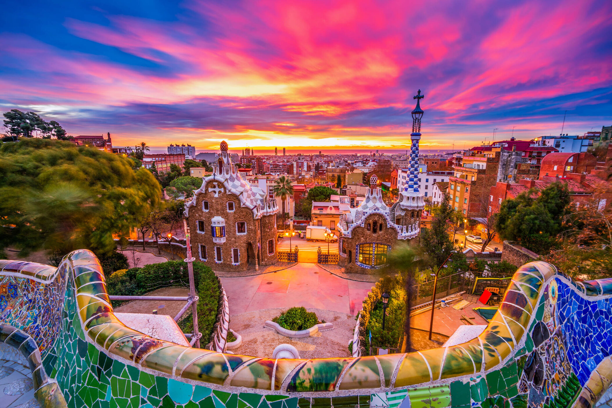 Beautiful sunrise in Barcelona seen from Park Guell. Park was built from 1900 to 1914 and was officially opened as a public park in 1926. In 1984, UNESCO declared the park a World Heritage Site