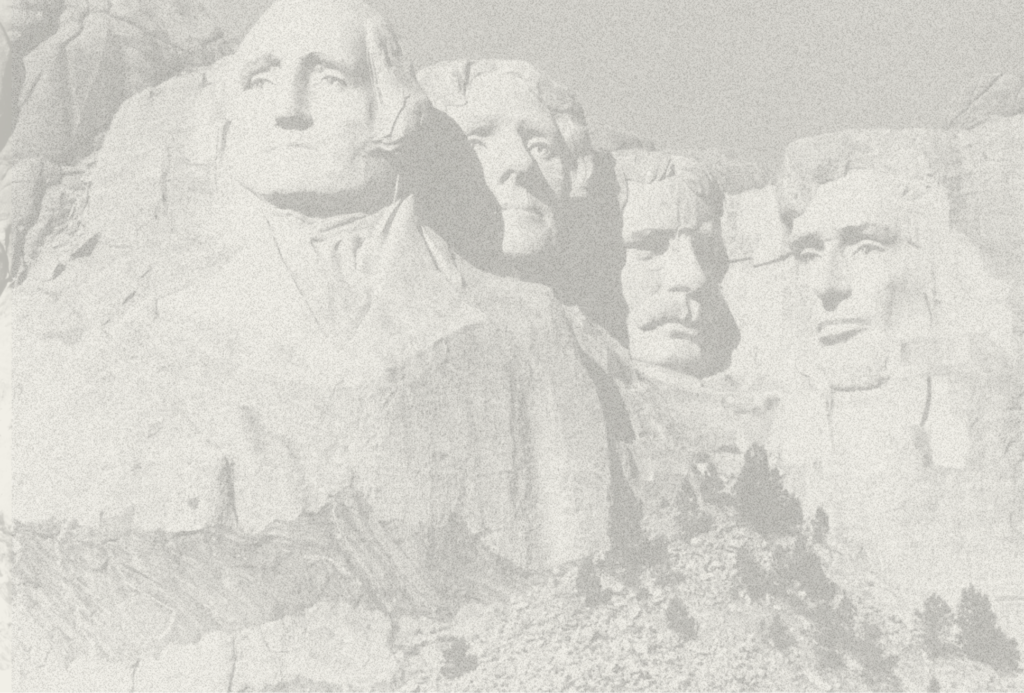 Grainy black and white image of Mount Rushmore.