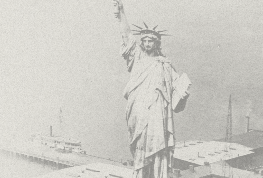 Grainy black and white image of the Statue of Liberty.
